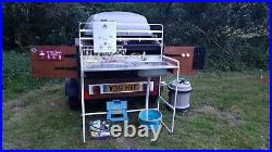 Camping trailer with pull-out sink and hot water