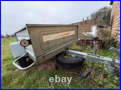 Erde car trailer for camping. Silver. Has a front wheel and a Winterhoff hitch
